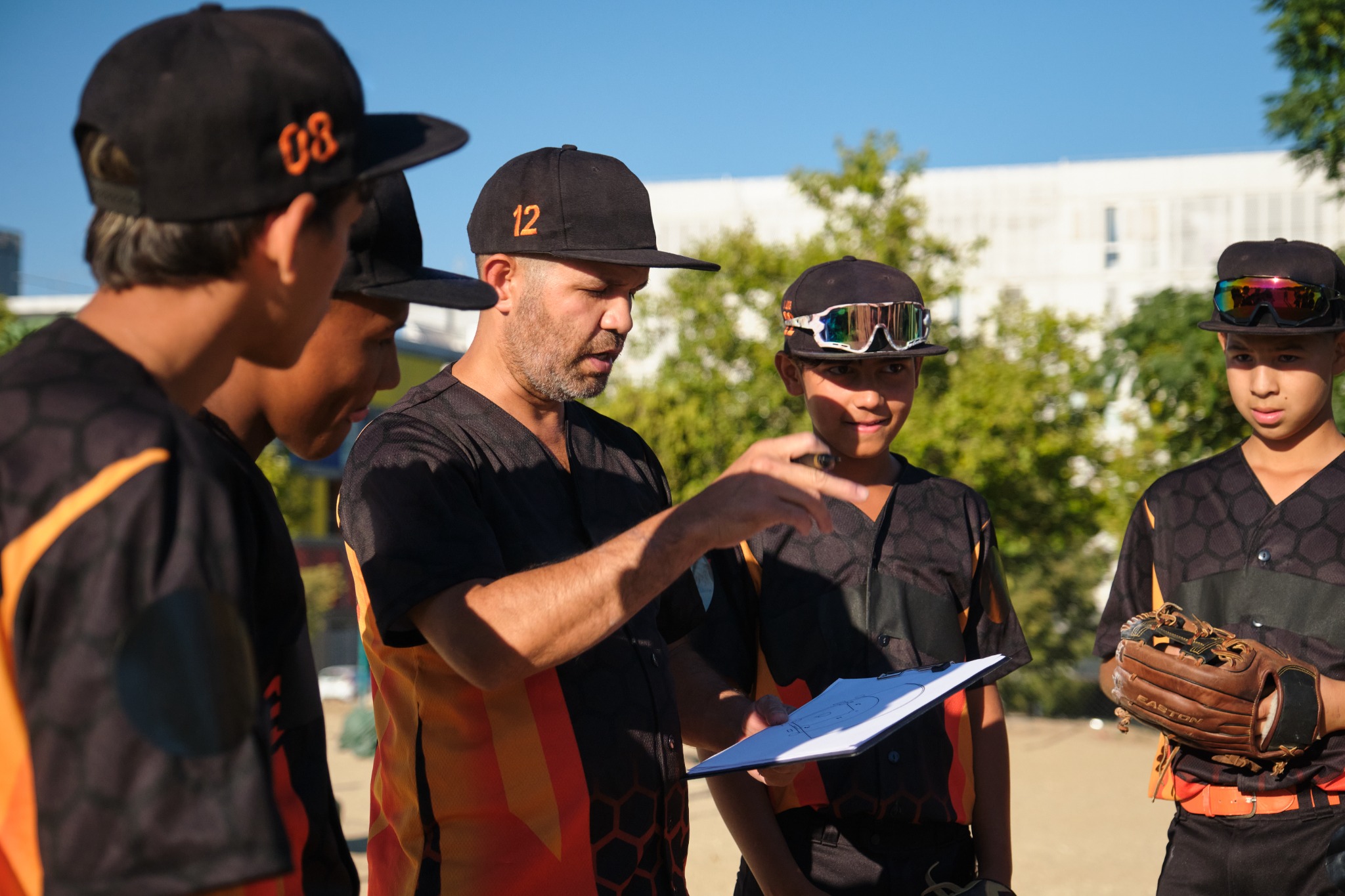 Youth baseball coach with players